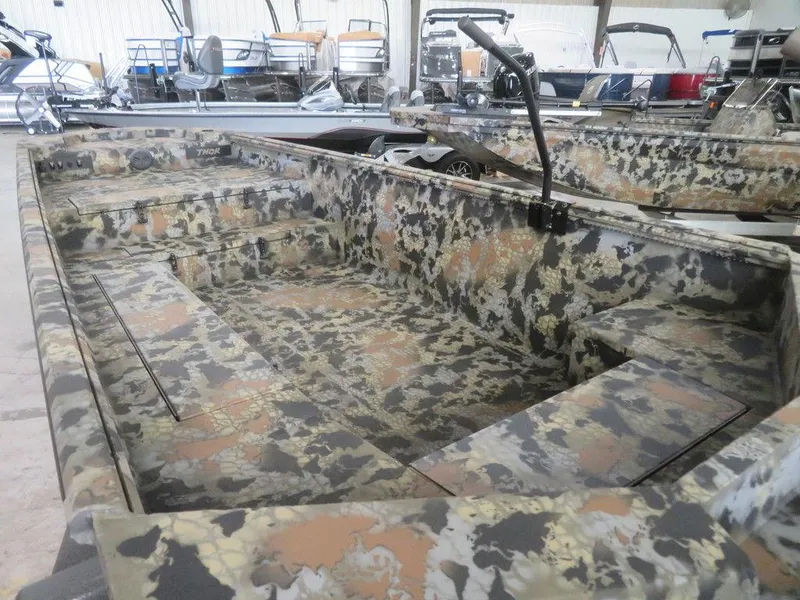 Slide: The Image of 2024 Thor SWAMP HAMMER 1754 DELUXE camo boat interior in showroom. - 13