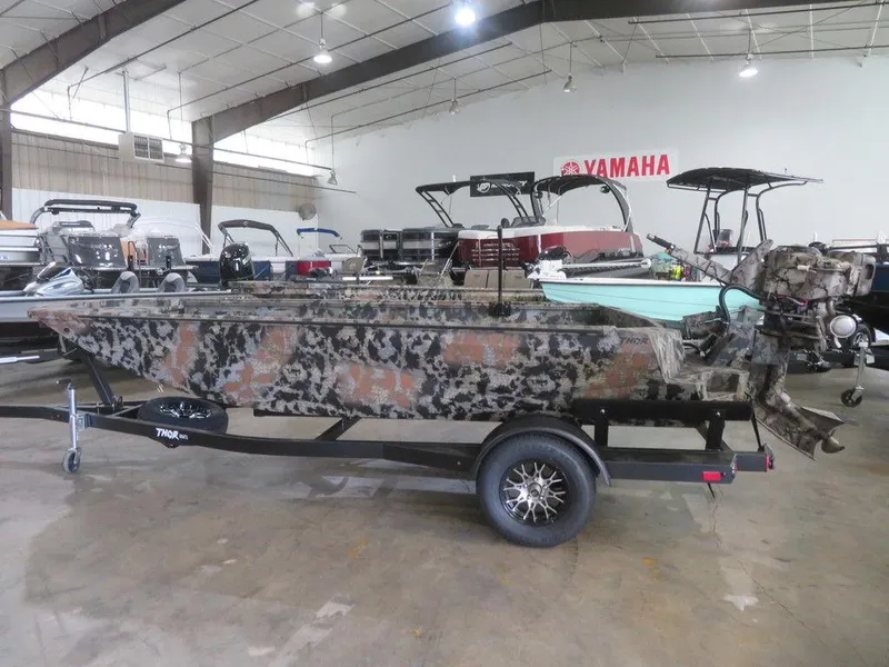 Slide: The Image of 2024 Thor SWAMP HAMMER 1754 DELUXE boat in showroom with camouflage design. - 3