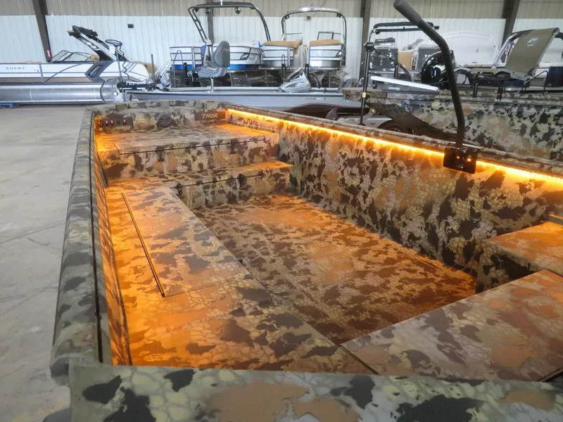 Slide: The Image of 2024 Thor SWAMP HAMMER 1754 DELUXE boat interior with camo design and LED lighting. - 4
