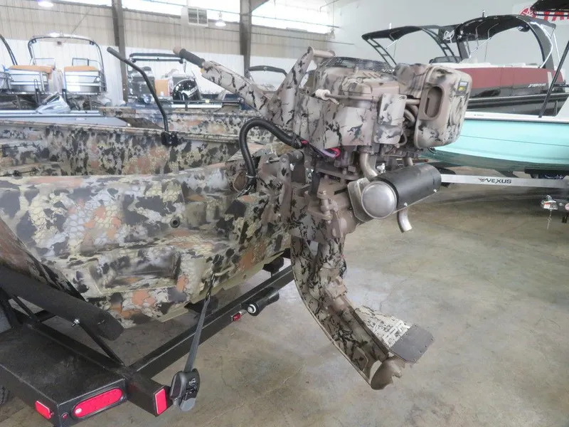 Slide: The Image of 2024 Thor SWAMP HAMMER 1754 DELUXE camo boat with outboard motor in showroom. - 7