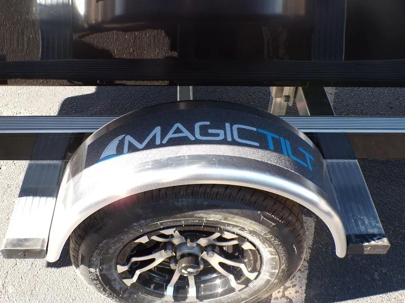Slide: The Image of Custom 1800 Tunnel 2024 trailer with Magic Tilt branding on wheel fender. - 13