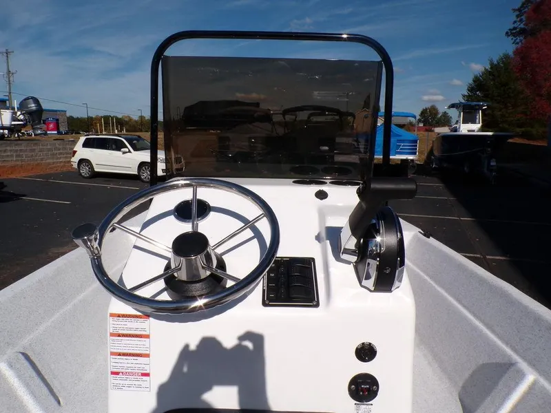 Slide: The Image of 2024 Custom 1800 Tunnel boat console with steering wheel and controls. - 16