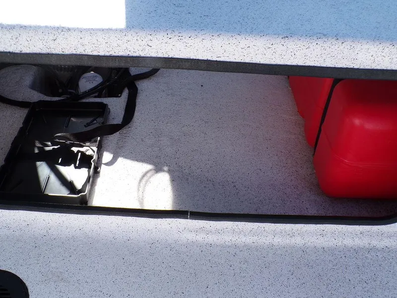 Slide: The Image of Storage compartment of 2024 Custom 1800 Tunnel boat with red fuel tank. - 18