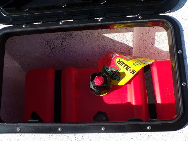 Slide: The Image of Custom 1800 Tunnel 2024 storage compartment with red fuel tank and Koller 12-pack. - 23
