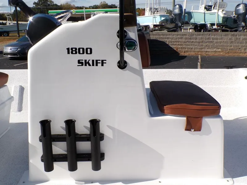 Slide: The Image of 2024 Custom 1800 Tunnel Skiff boat with rod holders and cushioned seat. - 24