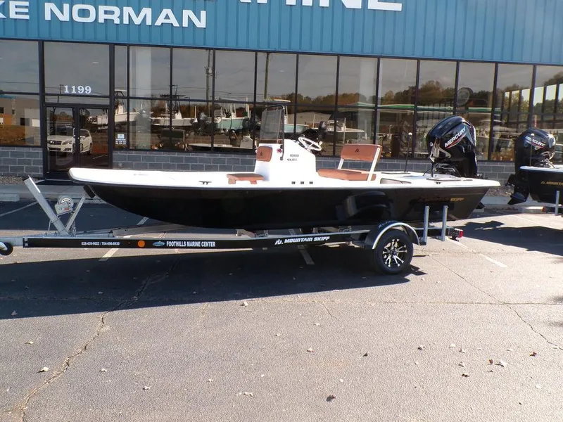 Slide: The Image of 2024 Custom 1800 Tunnel boat on trailer outside marine center. - 3