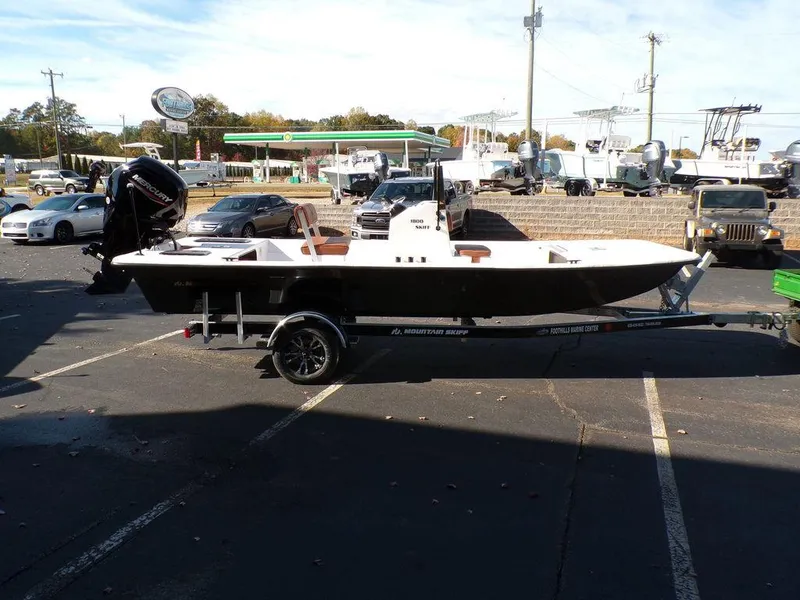 Slide: The Image of 2024 Custom 1800 Tunnel boat on a trailer in a parking lot. - 9