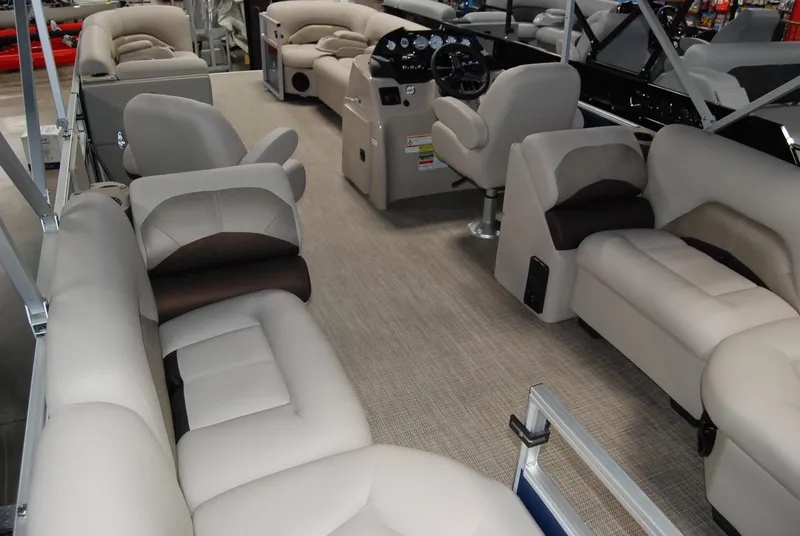 Slide: The Image of 2024 Landau Island Breeze 252 pontoon boat interior with plush seating and modern dashboard. - 3