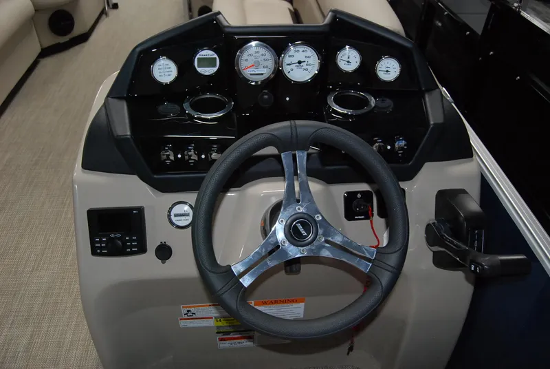 Slide: The Image of 2024 Landau Island Breeze 252 boat dashboard with steering wheel and gauges. - 5