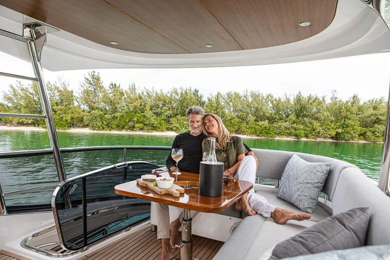 Slide: The Image of Couple relaxing on the deck of a 2024 Belize 54 Daybridge yacht. - 9