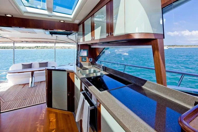 Slide: The Image of Luxurious kitchen interior of 2024 Belize 54 Sedan yacht with ocean view. - 5