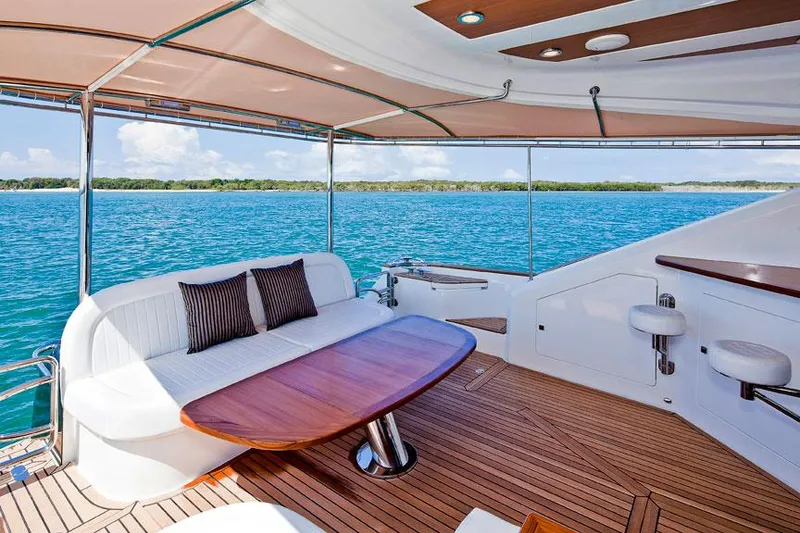 Slide: The Image of Luxurious deck of 2024 Belize 54 Sedan yacht with ocean view and comfortable seating. - 6
