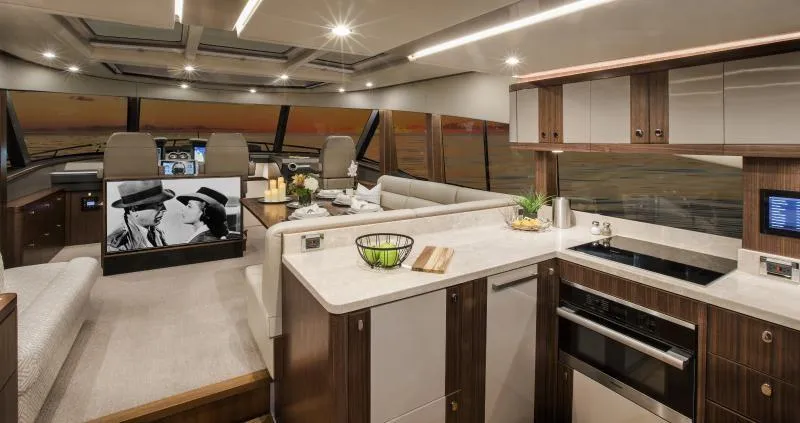 Slide: The Image of Luxurious interior of 2024 Belize 66 Sedan yacht with modern kitchen and entertainment area. - 11