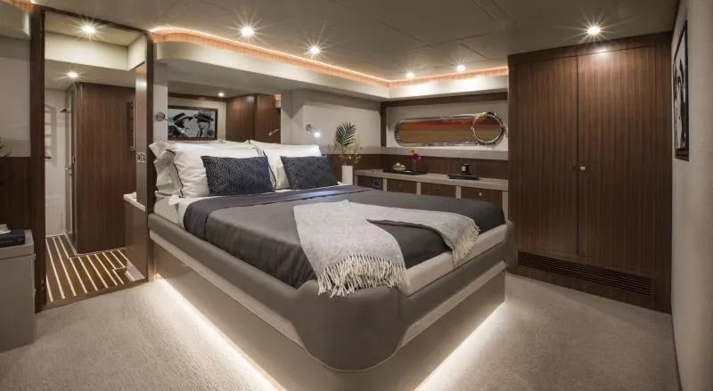 Slide: The Image of Luxurious master bedroom in 2024 Belize 66 Sedan yacht with modern decor and ambient lighting. - 12