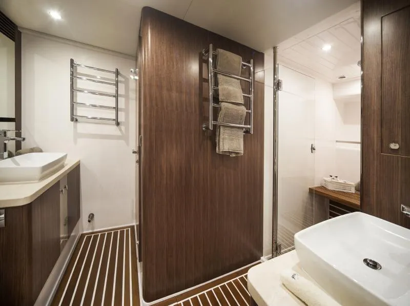 Slide: The Image of Luxurious bathroom in 2024 Belize 66 Sedan yacht with modern fixtures and wooden accents. - 17