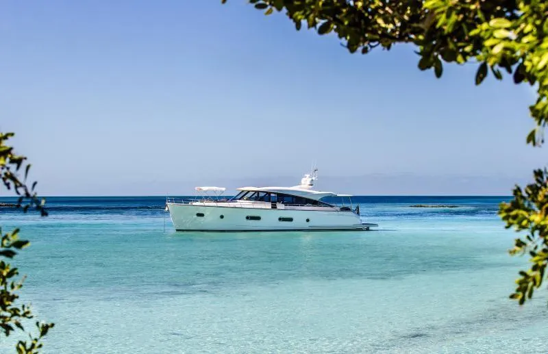 Slide: The Image of 2024 Belize 66 Sedan yacht cruising in clear blue waters. - 3