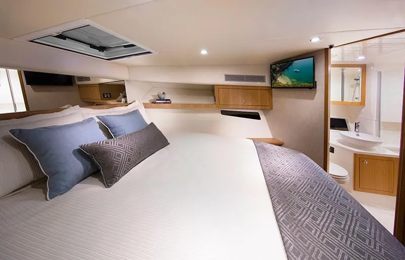 Slide: The Image of Luxurious bedroom in 2024 Riviera 395 SUV yacht with modern amenities. - 15