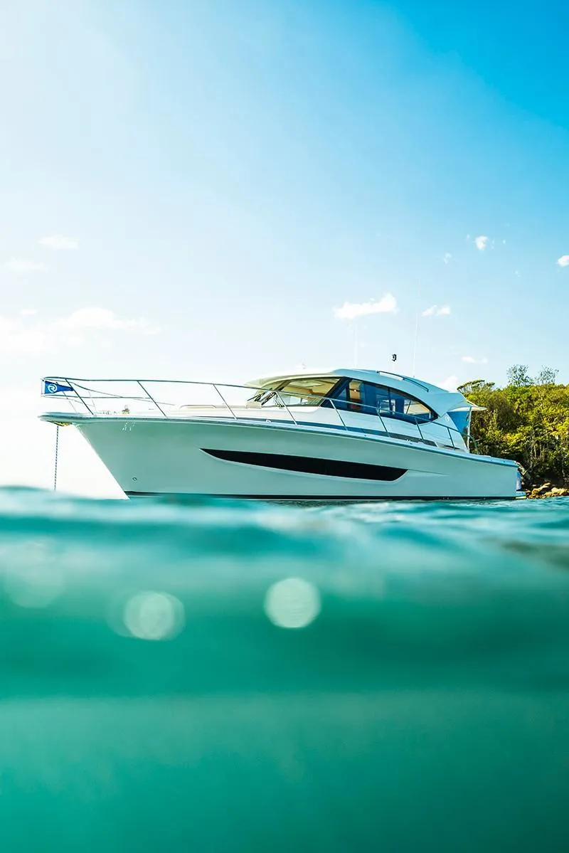 Slide: The Image of 2024 Riviera 395 SUV cruising on clear blue water. - 4