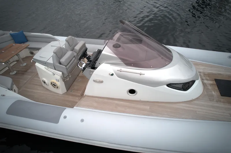 Slide: The Image of 2014 SACS Strider 13 boat with modern seating and control console. - 10