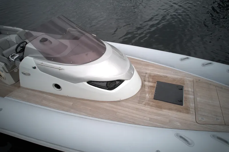Slide: The Image of 2014 SACS Strider 13 boat with sleek design on water. - 11