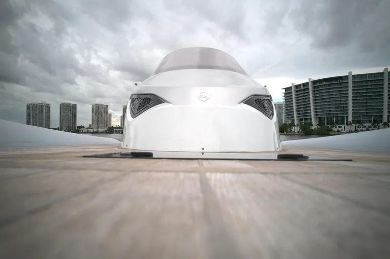 Slide: The Image of Front view of 2014 SACS Strider 13 yacht docked with cityscape background. - 16