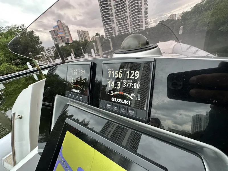 Slide: The Image of Close-up of the dashboard of a 2014 SACS Strider 13 boat with Suzuki displays. - 19