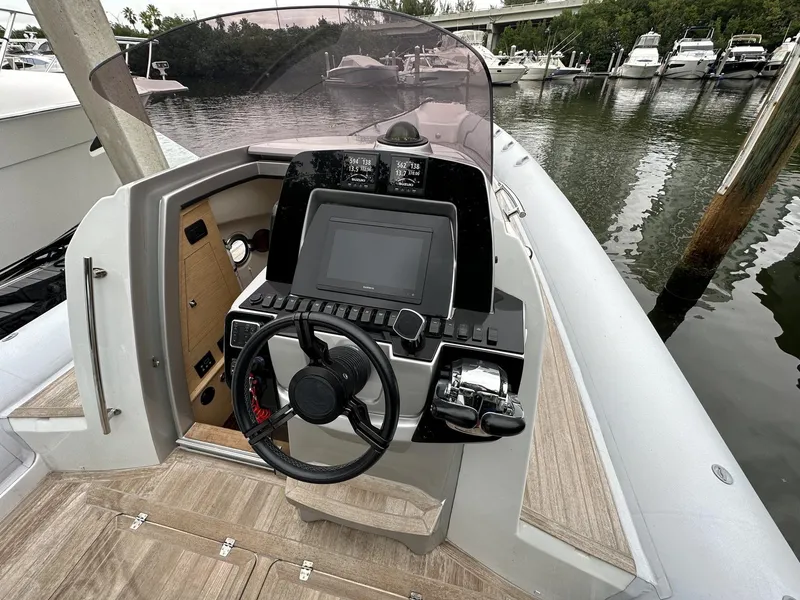Slide: The Image of 2014 SACS Strider 13 boat helm with steering wheel and navigation system. - 22