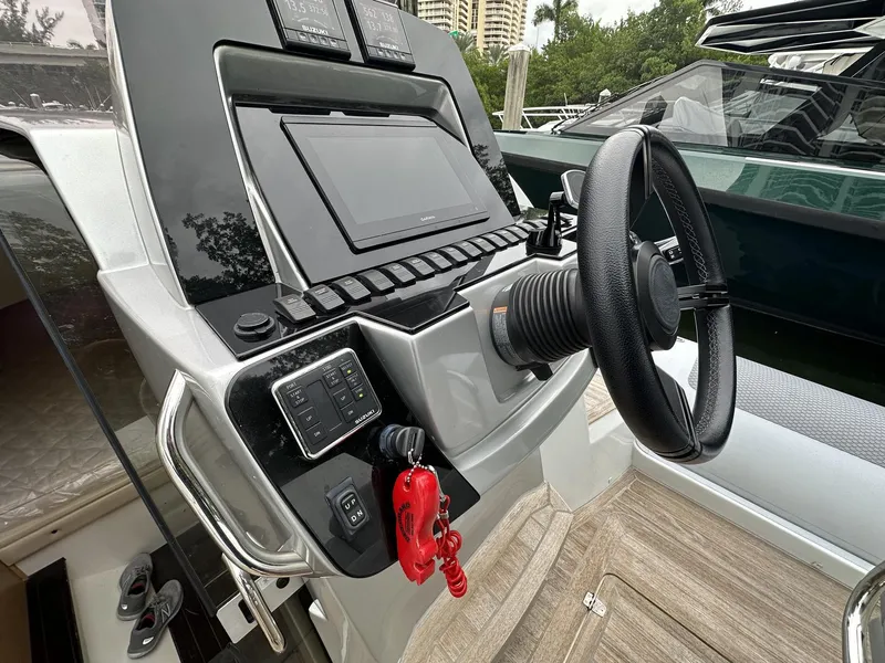 Slide: The Image of 2014 SACS Strider 13 boat dashboard with steering wheel and control panel. - 24