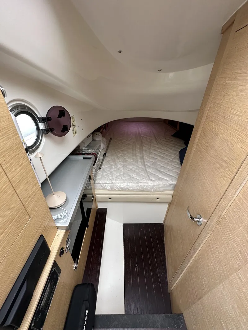 Slide: The Image of Interior cabin of a 2014 SACS Strider 13 boat with bed and storage. - 28