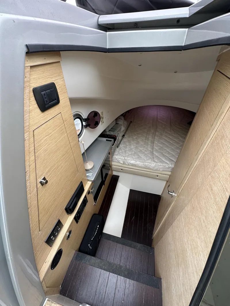 Slide: The Image of Interior cabin of a 2014 SACS Strider 13 boat with bed and control panel. - 29