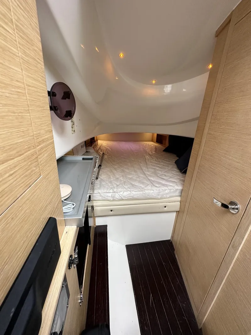 Slide: The Image of Interior cabin of 2014 SACS Strider 13 with bed and wooden finishes. - 31