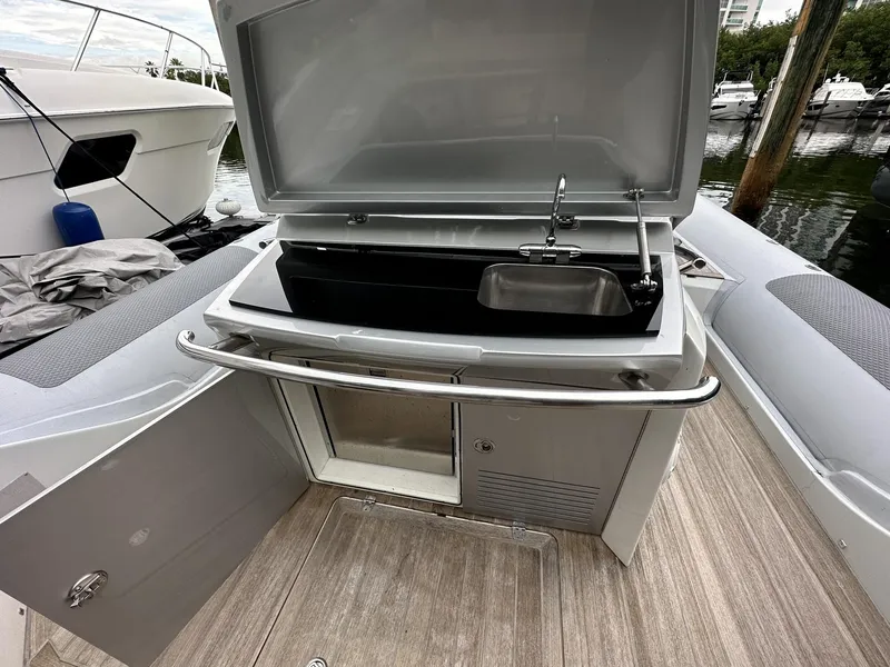 Slide: The Image of 2014 SACS Strider 13 boat with open storage compartment and sink. - 34