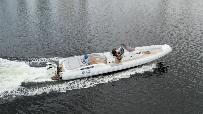 Slide: The Image of 2014 SACS Strider 13 luxury boat cruising on water. - 39
