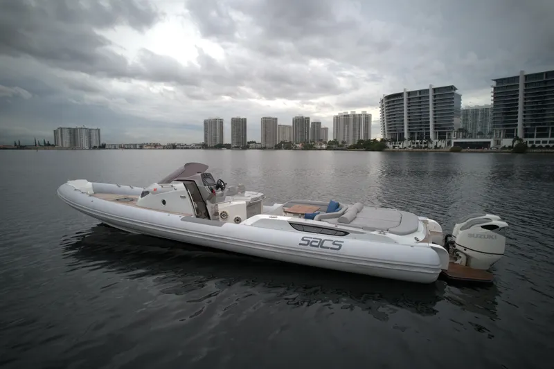 Slide: The Image of 2014 SACS Strider 13 boat on calm water with cityscape background. - 4