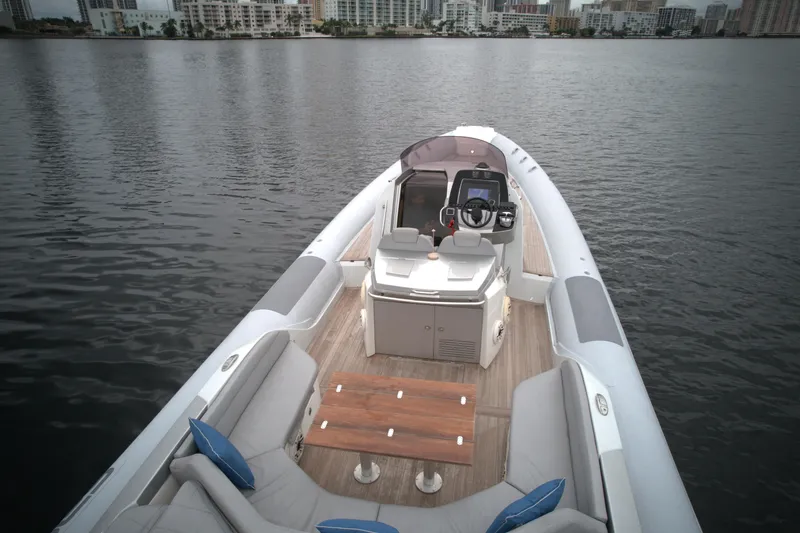 Slide: The Image of 2014 SACS Strider 13 boat with seating and control console on calm water. - 6