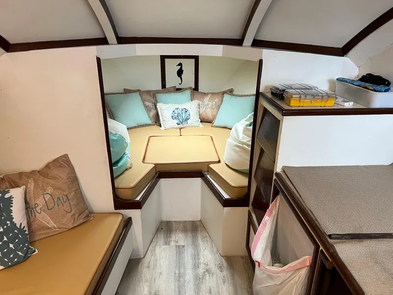 Slide: The Image of Cozy interior of 1985 Custom Mabry Edwards boat with cushions and storage. - 13
