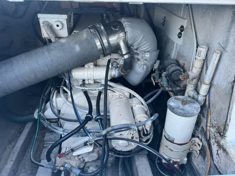 Slide: The Image of 1985 Custom Mabry Edwards engine with hoses and components in a confined space. - 16
