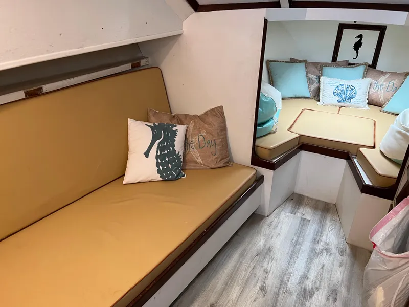 Slide: The Image of Cozy interior of 1985 Custom Mabry Edwards boat with beige seating and decorative pillows. - 17