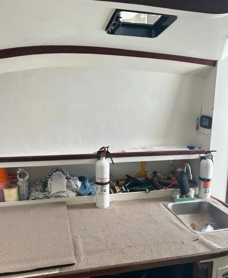 Slide: The Image of 1985 Custom Mabry Edwards boat interior with workbench, tools, and fire extinguishers. - 21