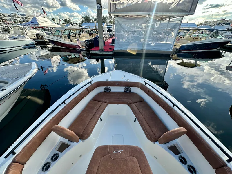 Slide: The Image of Scout 260 LXF 2025 at a boat show, bow deck view. - 4