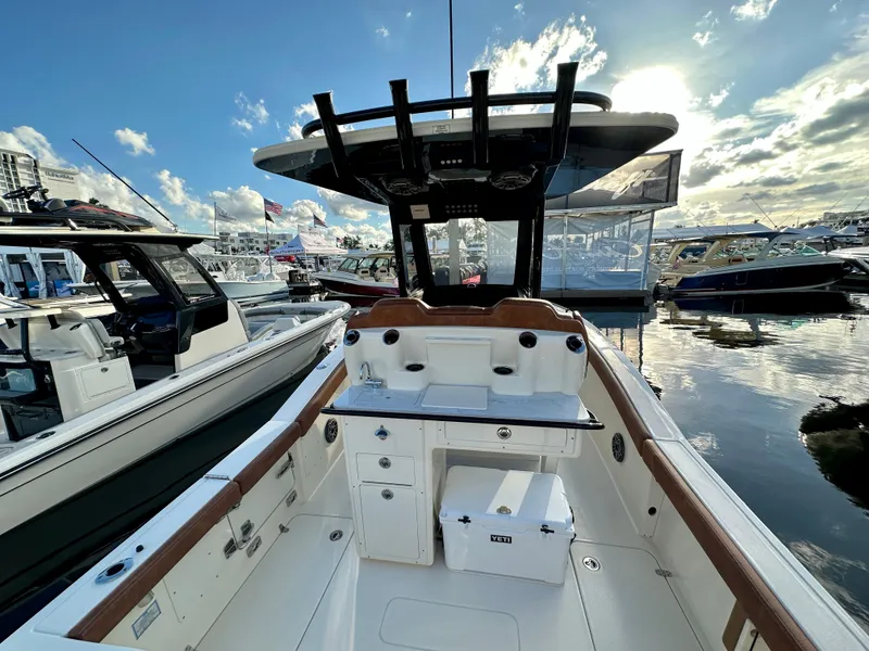 Slide: The Image of Scout 260 LXF 2025 boat docked at sunset. - 6