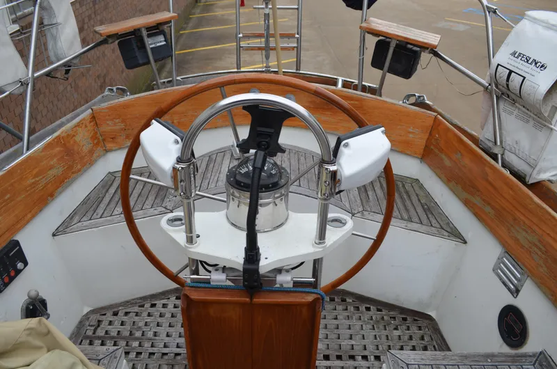 Slide: The Image of 1977 Cheoy Lee 41' Offshore yacht helm with wooden wheel and navigation instruments. - 11