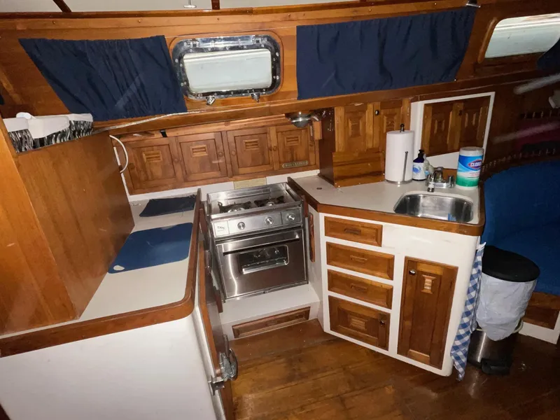 Slide: The Image of 1977 Cheoy Lee 41' Offshore yacht kitchen with wood cabinetry and stainless steel appliances. - 15