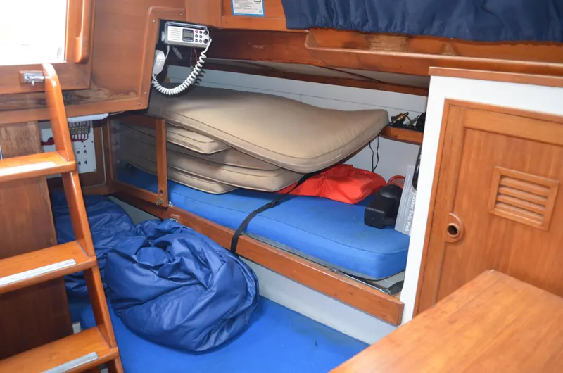 Slide: The Image of 1977 Cheoy Lee 41' Offshore cabin interior with cushions and marine radio. - 18