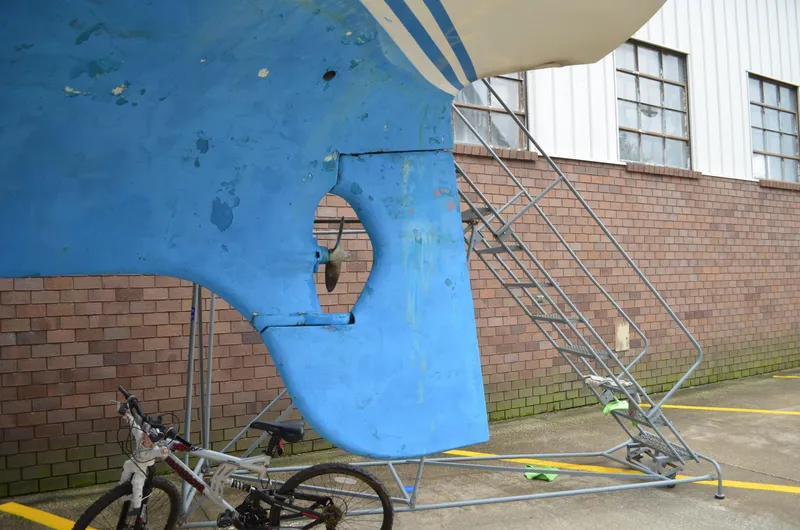 Slide: The Image of 1977 Cheoy Lee 41' Offshore sailboat hull in dry dock with bicycles nearby. - 4