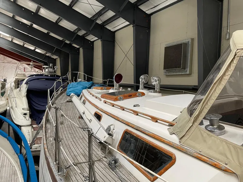 Slide: The Image of 1977 Cheoy Lee 41' Offshore yacht in storage, showcasing deck and cabin details. - 8