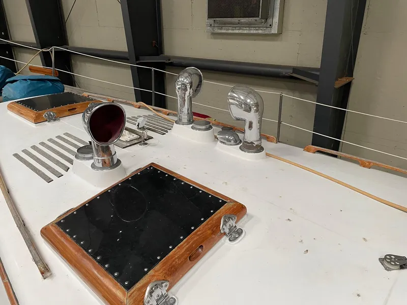 Slide: The Image of 1977 Cheoy Lee 41' Offshore yacht deck with chrome fittings and wooden accents. - 9