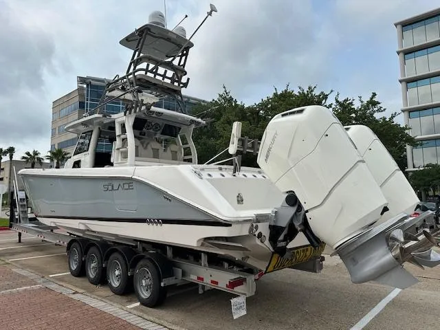 Slide: The Image of 2023 Solace 41 CS boat on trailer with twin outboard engines. - 3