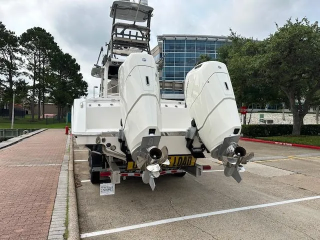 Slide: The Image of 2023 Solace 41 CS boat with dual outboard engines in a parking lot. - 4