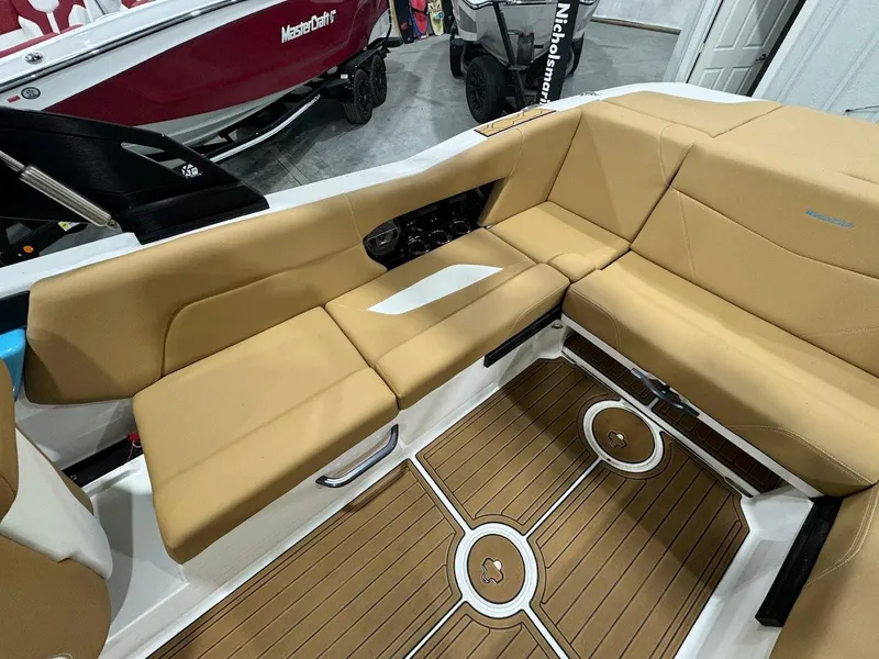 Slide: The Image of 2022 MasterCraft NXT24 boat interior with tan seating and teak flooring. - 10
